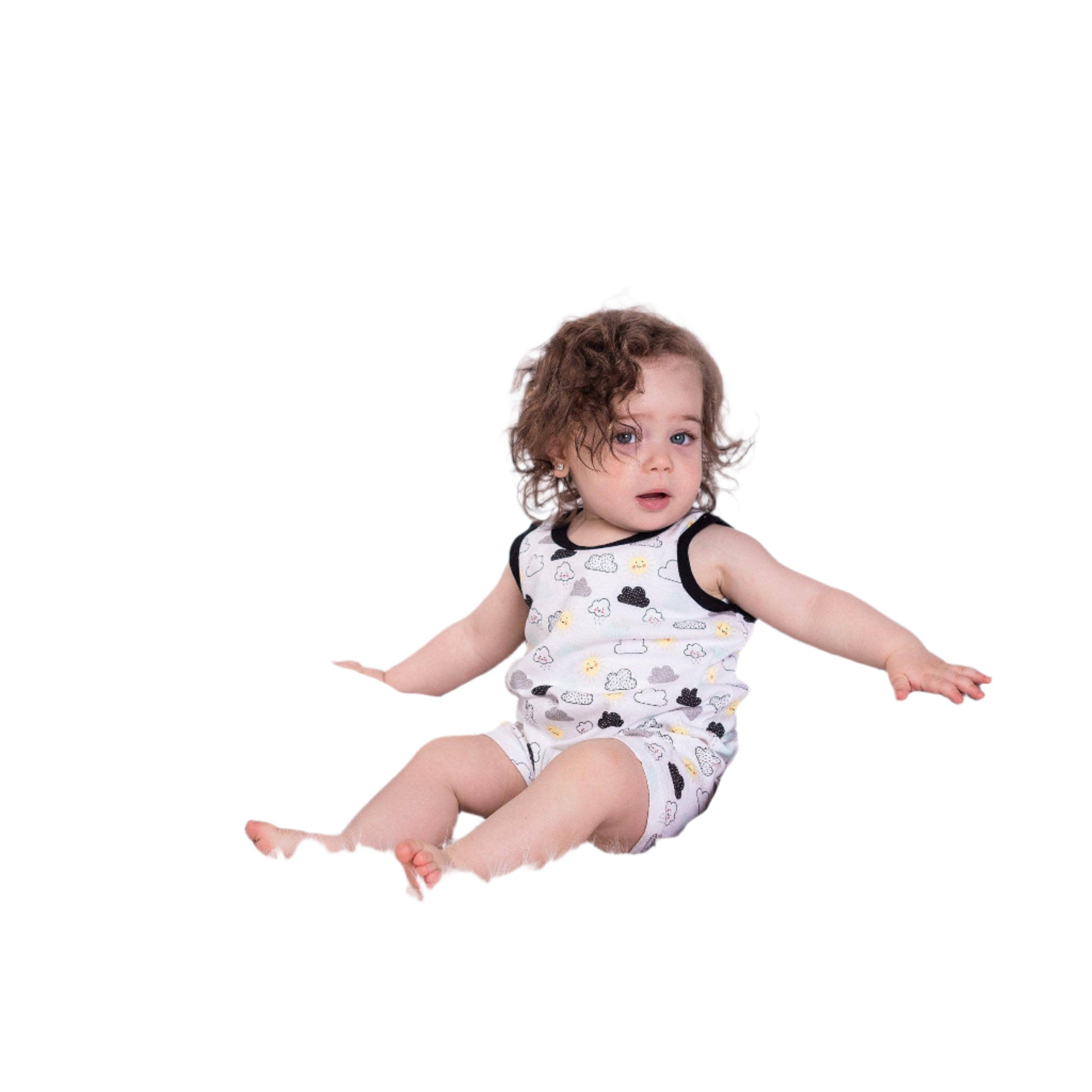 Baby sitting on a fluffy white surface wearing a sleeveless romper with black details.
